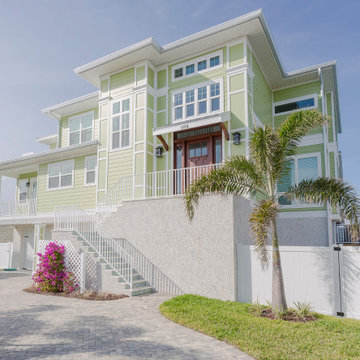 Contemporary Coastal Home with Elevated Entry and Palm Accents
