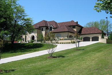 Example of a mid-sized trendy red two-story stucco exterior home design in Oklahoma City with a hip roof