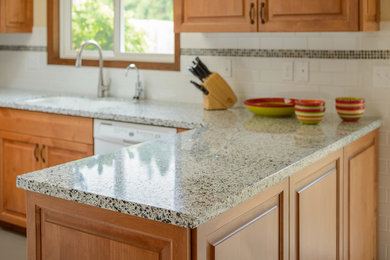 Kitchen - traditional kitchen idea in Other with raised-panel cabinets, medium tone wood cabinets, recycled glass countertops, white backsplash and ceramic backsplash