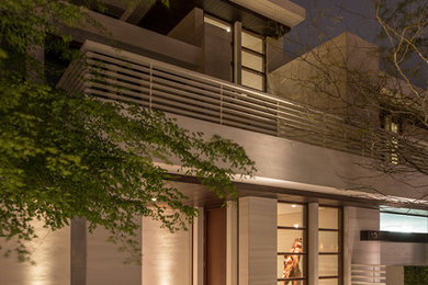 Entryway - huge coastal limestone floor and beige floor entryway idea in Miami with beige walls and a dark wood front door