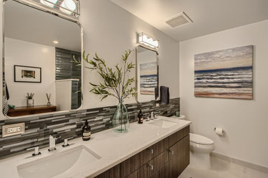 Mid-sized transitional 3/4 blue tile and glass sheet porcelain tile, gray floor and double-sink bathroom photo in Denver with flat-panel cabinets, dark wood cabinets, a one-piece toilet, an undermount sink, quartz countertops, white countertops and a floating vanity