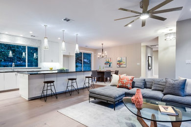 Family room - large contemporary open concept light wood floor family room idea in Austin with gray walls and a wall-mounted tv