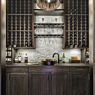 Mediterranean single-wall wet bar in Miami with a built-in sink, shaker cabinets, dark wood cabinets, grey splashback, dark hardwood flooring and black floors.