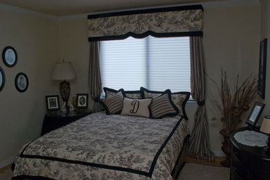 Inspiration for a timeless guest medium tone wood floor bedroom remodel in Santa Barbara with beige walls