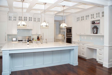Large transitional dark wood floor eat-in kitchen photo in Other with an undermount sink, recessed-panel cabinets, white cabinets, marble countertops, blue backsplash, ceramic backsplash, stainless steel appliances and an island