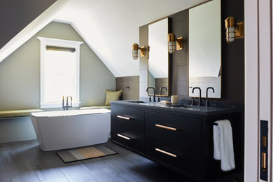 Large transitional master beige tile and porcelain tile porcelain tile, gray floor, double-sink and vaulted ceiling bathroom photo in New York with flat-panel cabinets, black cabinets, a two-piece toilet, an undermount sink, a hinged shower door, gray countertops, a floating vanity and white walls