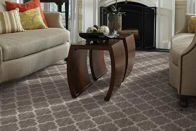 Example of a transitional enclosed carpeted living room design in Minneapolis with beige walls, a standard fireplace and a plaster fireplace