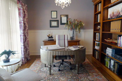 Inspiration for a mid-sized timeless freestanding desk medium tone wood floor study room remodel in Columbus with purple walls