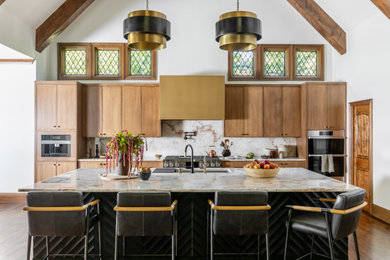 Example of a large transitional galley medium tone wood floor, brown floor and vaulted ceiling open concept kitchen design in Other with a single-bowl sink, medium tone wood cabinets, quartzite countertops, white backsplash, stone slab backsplash, stainless steel appliances, an island and white countertops