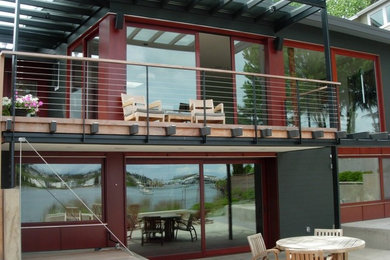 Large black two-story concrete fiberboard flat roof photo in Seattle