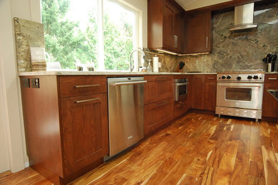 Mid-sized l-shaped light wood floor kitchen photo in Seattle with medium tone wood cabinets, granite countertops, gray backsplash, stainless steel appliances and an island