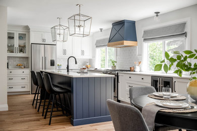 Large traditional l-shaped kitchen in Toronto with shaker cabinets and an island.