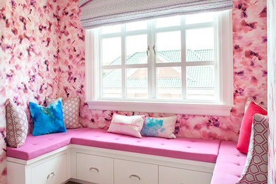 Example of a large trendy guest light wood floor bedroom design in New York with pink walls and no fireplace
