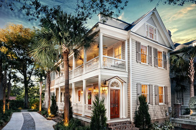 Mid-sized traditional beige three-story wood exterior home idea in Charleston with a metal roof