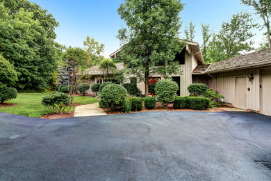 Example of a transitional one-story wood exterior home design in Cleveland