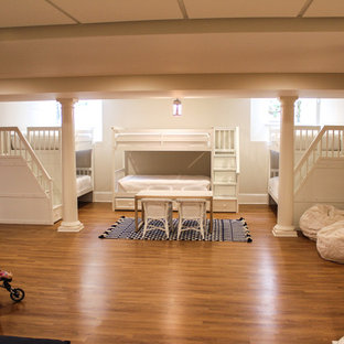 Inspiration for an expansive beach style fully buried basement in New York with beige walls, no fireplace and medium hardwood flooring.
