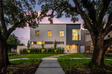 Photo of a modern two-storey stucco house exterior in Houston with a flat roof.