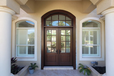 Inspiration for a large double front door remodel in Tampa with a dark wood front door