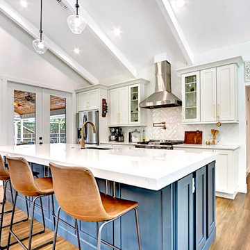 White kitchen with blue island in Whispering Trails
