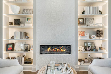 Mid-sized transitional enclosed dark wood floor and beige floor living room library photo in Orlando with beige walls, a ribbon fireplace, a tile fireplace and no tv