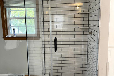 Corner shower - master corner shower idea in Boston with a hinged shower door