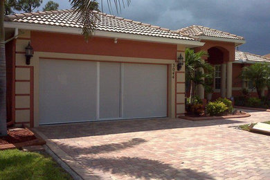 Mid-sized transitional attached two-car garage photo in Denver