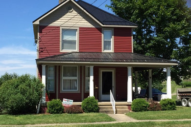 Example of a red vinyl exterior home design in Columbus