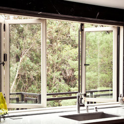 Bi-fold window opens the kitchen directly to the deck outside - Windows And Doors