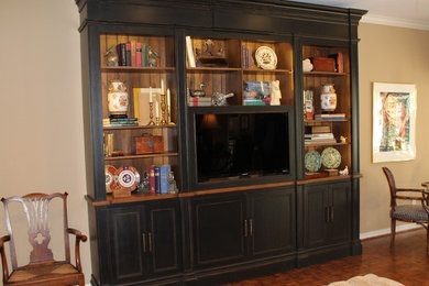 This is an example of a traditional family room in New Orleans with a concealed tv.