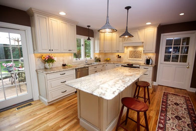 Inspiration for a large traditional l-shaped eat-in kitchen in Philadelphia with an undermount sink, recessed-panel cabinets, white cabinets, granite benchtops, stainless steel appliances, medium hardwood floors and with island.
