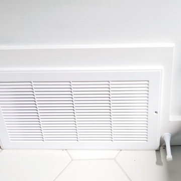 White Wall Grille Above the Bathroom’s Hexagon Tile Floor | High Park Toronto