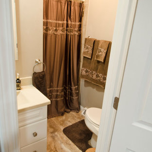 Klassisk inredning av ett mellanstort beige beige kök, med en undermonterad diskho, luckor med upphöjd panel, skåp i ljust trä, bänkskiva i kvarts, flerfärgad stänkskydd, stänkskydd i travertin, vita vitvaror, vinylgolv, en köksö och beiget golv