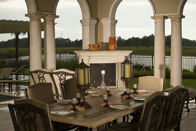 Mid-sized elegant backyard patio photo in Tampa with a fire pit and a roof extension