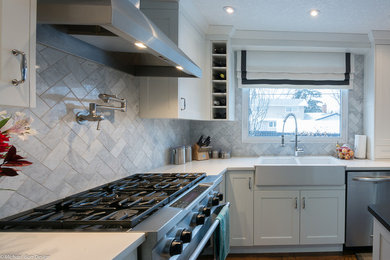 Design ideas for a mid-sized transitional u-shaped eat-in kitchen in Calgary with a farmhouse sink, recessed-panel cabinets, white cabinets, quartz benchtops, white splashback, subway tile splashback, stainless steel appliances, medium hardwood floors and with island.