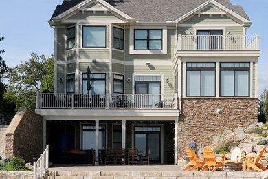Inspiration for a large timeless green three-story concrete exterior home remodel in Chicago