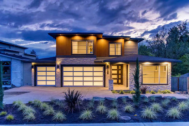 Large contemporary gray three-story concrete fiberboard exterior home idea in Portland with a shingle roof