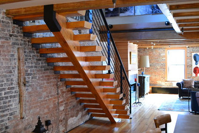 Living room - mid-sized country formal and loft-style medium tone wood floor and brown floor living room idea in Boston with brown walls, no fireplace and no tv