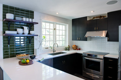 Transitional kitchen photo in Toronto with an undermount sink, flat-panel cabinets, dark wood cabinets, white backsplash, subway tile backsplash and stainless steel appliances