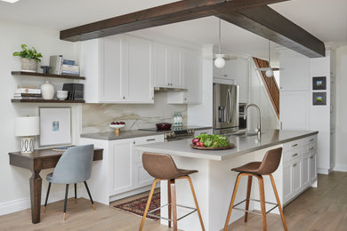 Eat-in kitchen - mid-sized transitional galley light wood floor and beige floor eat-in kitchen idea in Raleigh with a double-bowl sink, shaker cabinets, white cabinets, quartz countertops, beige backsplash, stone slab backsplash, stainless steel appliances, an island and gray countertops