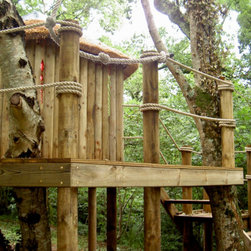 Stunning craftsmanship allows the forest to be a part of your treehouse, constru - Garden Playhouses