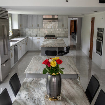 Transitional Kitchen Done in a 2 Tone Color With Integrated Dining Table