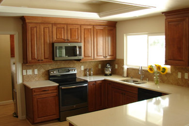 Example of a mid-sized classic u-shaped light wood floor open concept kitchen design in Sacramento with a double-bowl sink, raised-panel cabinets, medium tone wood cabinets, quartz countertops, brown backsplash, porcelain backsplash, stainless steel appliances and a peninsula