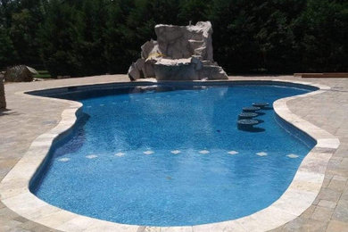 Pool landscaping - large traditional backyard brick and custom-shaped pool landscaping idea in Louisville