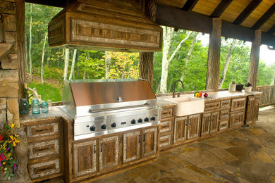 Outdoor kitchen deck - rustic backyard outdoor kitchen deck idea in Charlotte with a roof extension