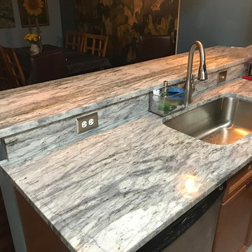 Welcoming, traditional design kitchen in "Thunder White" granite countertops