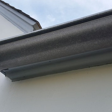 Bonderized Steel, 5 inch Half Round Seamless Gutters with Round Downspouts.