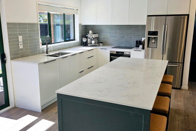 Kitchen - huge traditional kitchen idea in Christchurch with recessed-panel cabinets, quartz countertops and an island