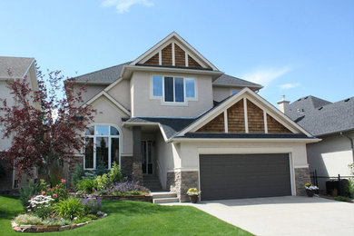 This is an example of a mid-sized transitional two-storey beige exterior in Calgary.