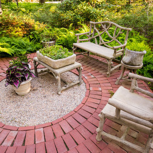 Photo of a small contemporary backyard patio in Boston with brick pavers and no cover.