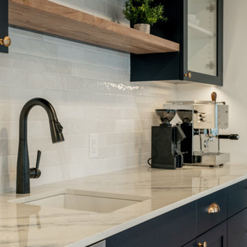 Navy Wet Bar with Glass-Front Cabinets and Natural Wood Floating Shelves